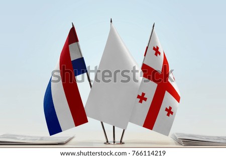 Flags of Netherlands and Georgia with a white flag in the middle