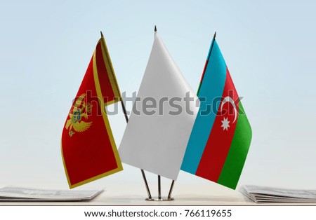 Flags of Montenegro and Azerbaijan with a white flag in the middle