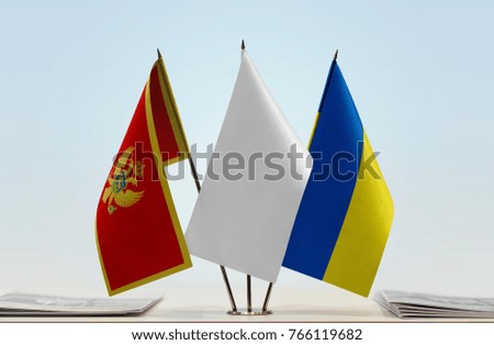 Flags of Montenegro and Ukraine with a white flag in the middle
