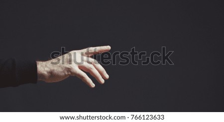 male hand on a dark background