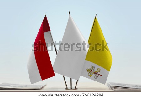 Flags of Monaco and Vatican City with a white flag in the middle