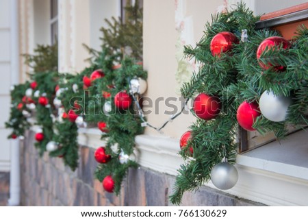 Closeup shoot of christmas decoration balls on facade of a restaurant