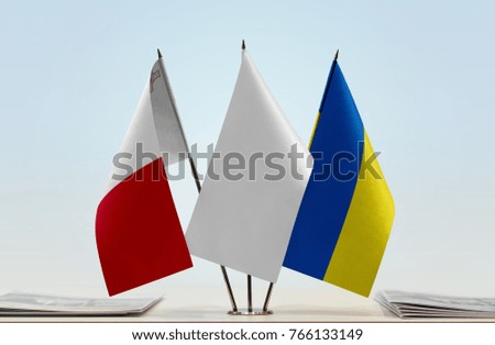 Flags of Malta and Ukraine with a white flag in the middle