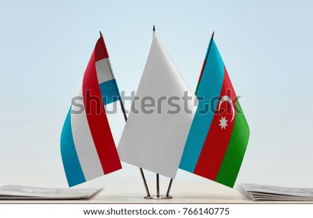 Flags of Luxembourg and Azerbaijan with a white flag in the middle