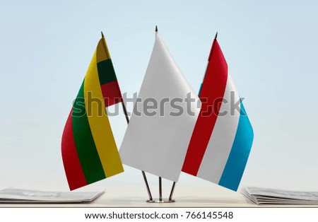Flags of Lithuania and Luxembourg with a white flag in the middle
