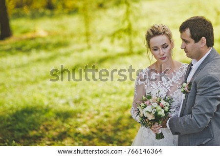 Newlyweds on the background of spruce forests.