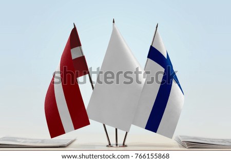 Flags of Latvia and Finland with a white flag in the middle
