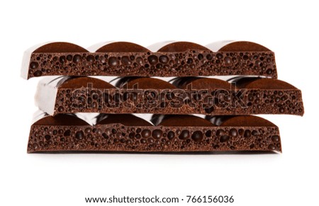 Dark porous chocolate isolated on white background