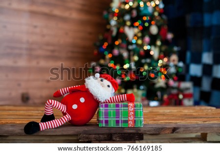
toy Santa Claus on the background of a Christmas tree