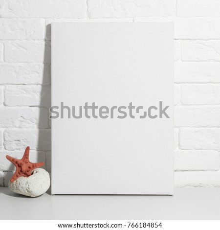 Mock up poster in white interior. Blank canvas, marine theme on background.