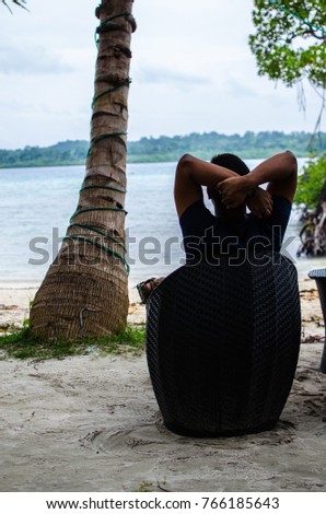 Sitting on the beach facing the sea