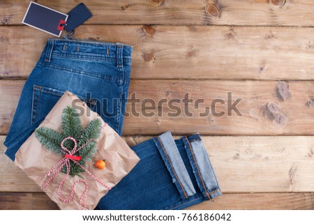 gift and spruce branches on a brown wooden background