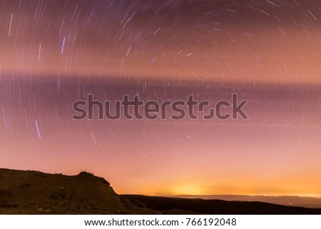 A shoot of a long exposure star trails taken at night, taken in the Negev desert, Israel national trail.
