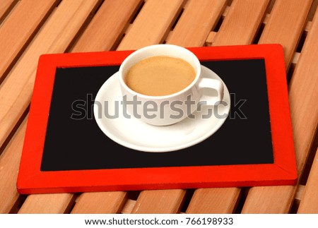 Cup of Tea on top of chalkboard in office