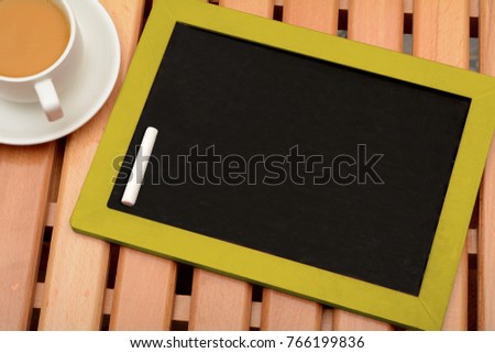 Empty Chalkboard Slate with Cup of Tea on Table Copy Space
