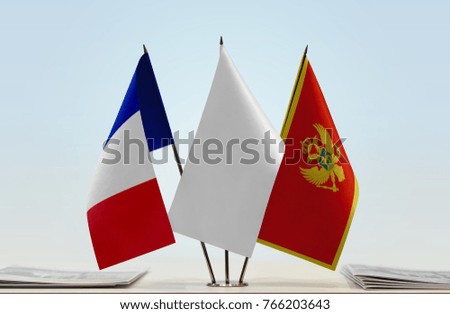 Flags of France and Montenegro with a white flag in the middle