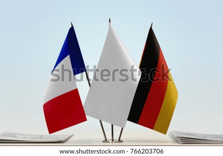Flags of France and Germany with a white flag in the middle