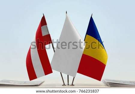 Flags of Austria and Romania with a white flag in the middle