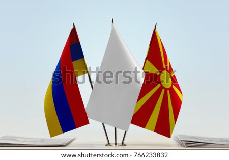 Flags of Armenia and Macedonia with a white flag in the middle