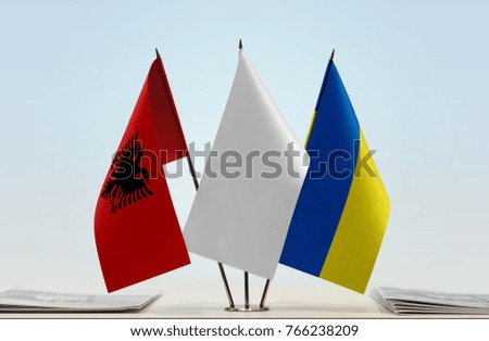 Flags of Albania and Ukraine with a white flag in the middle