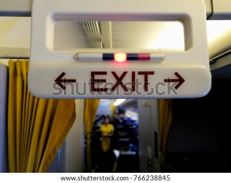 Exit and toilet sign on plane