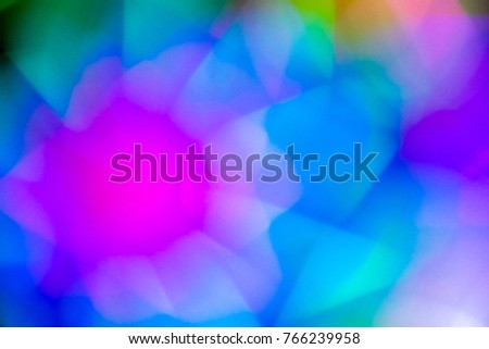 Abstract blurred multicolor neon light move to circle look like turbine, windmill,wind-wheel in party night for colorful title background,pattern ,texture with copy space.Rainbow light background.
