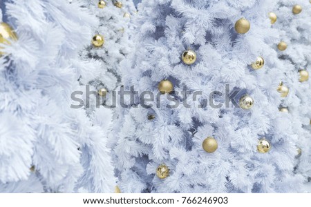 Christmas concept : Decorated artificial white Christmas trees and shiny golden Christmas balls