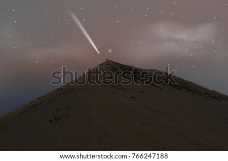 White comet over the sand mountain in morning sky