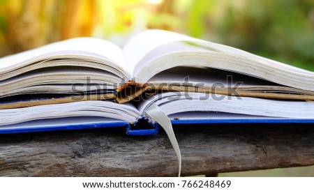 Open books on wooden table on soft light background. Toned image. Education themes