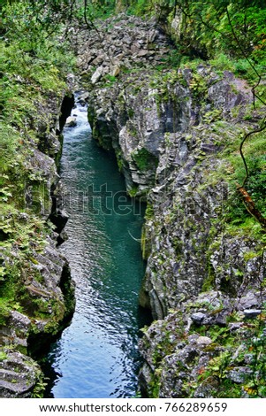 Takachiho Gorge, a narrow chasm cut through the rock by Gokase River with nearly sheer cliffs lining the gorge are made of slow forming volcanic basalt columns, Takachiho, Nishiusuki, Miyazaki, Japan