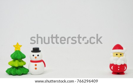 Small figurine of Santa Claus, Snowman, Christmas tree, decorated on a white background.