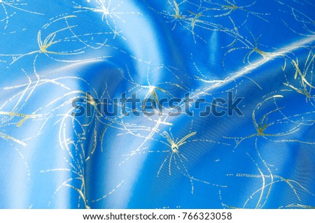 Background texture, pattern. Fabric blue silk with gold pattern. Created in the Renaissance style, the image of fruit twists around each other with golden branches on soft luminous silk.
