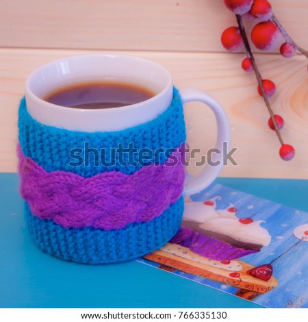 Postcard with beautiful picture, large bright tea cup and christmas wooden snowflakes