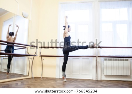 Girl exercising on the rhythmic gymnastics