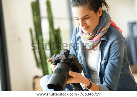 Photographer checking photo shots on camera screen