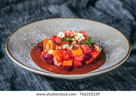 Delicious fruit salad on plate, closeup