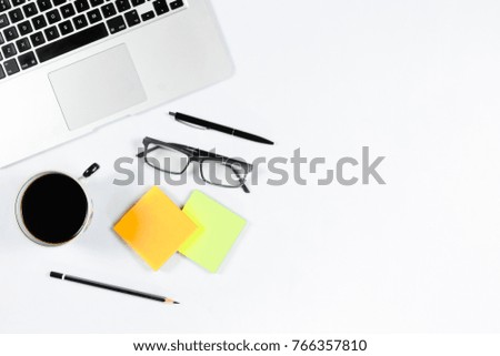 Working table top view, flat lay. Business items on a white table, laptop, phone, pens, stickers. Copy Space, Concept of business attributes.
