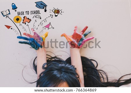 Education , art and creativity learning concept - A black long hair asian student put her colourful hands painting up