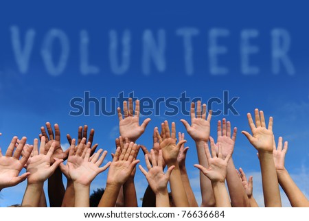 volunteer group raising hands against blue sky background Royalty-Free Stock Photo #76636684
