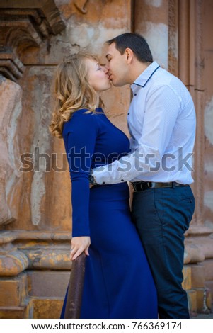Beautiful middle age couple at good day stay at old church. Happy stylish couple, at old Europe. Loving man and woman. Lovers near on gothic church in the middle of modern city