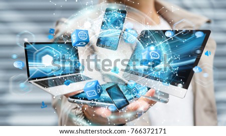 Tech devices connected to each other by businessman on blurred background 3D rendering Royalty-Free Stock Photo #766372171