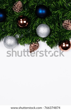 Christmas holiday background. Christmas still life. Blue and silver glitter ball, spruce branches and decorative christmas ornaments on a white background with copy-space. Top view.