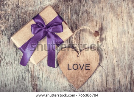 Wooden valentine and gift box with bow. Festive decorations. Romantic concept.