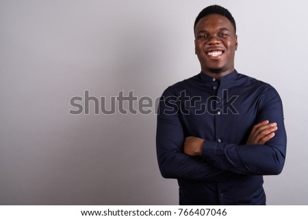 Studio shot of young African businessman against white background
