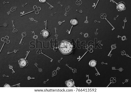pocket watch and old keys. Vintage Wonderland background. Soft selective focus, black and white photo