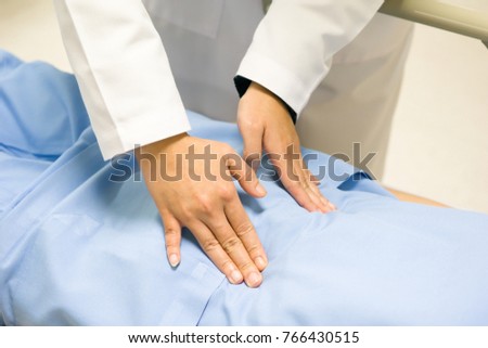Professional doctor is checking the abdominal pain of the patient. Medical and healthcare concept