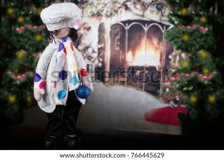Handmade doll in the New Year's interior. New Year card