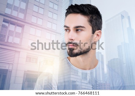 Stylish beard. Handsome brunette male turning head while looking aside and being deep in thoughts