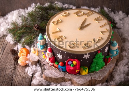 Happy New Year Cake. Christmas cake clock, decorated with Christmas tree figures, bears, deer, Christmas tree, sledges, gifts, a train, a snowman, snowflakes, stars