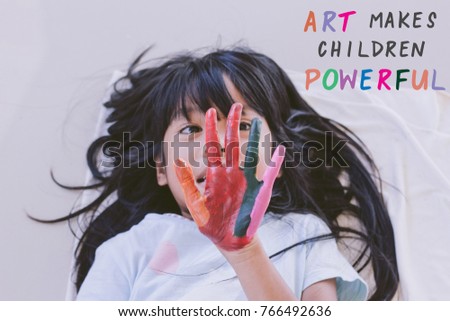Education , Art and creativity learning concept - A black long hair asian student put her colourful hands painting up with art quote - Art makes children powerful